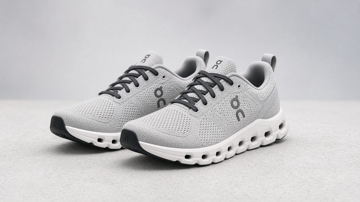 Pair of light grey cloud-cushion running shoes on a neutral studio background
